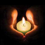 Hands holding a candle